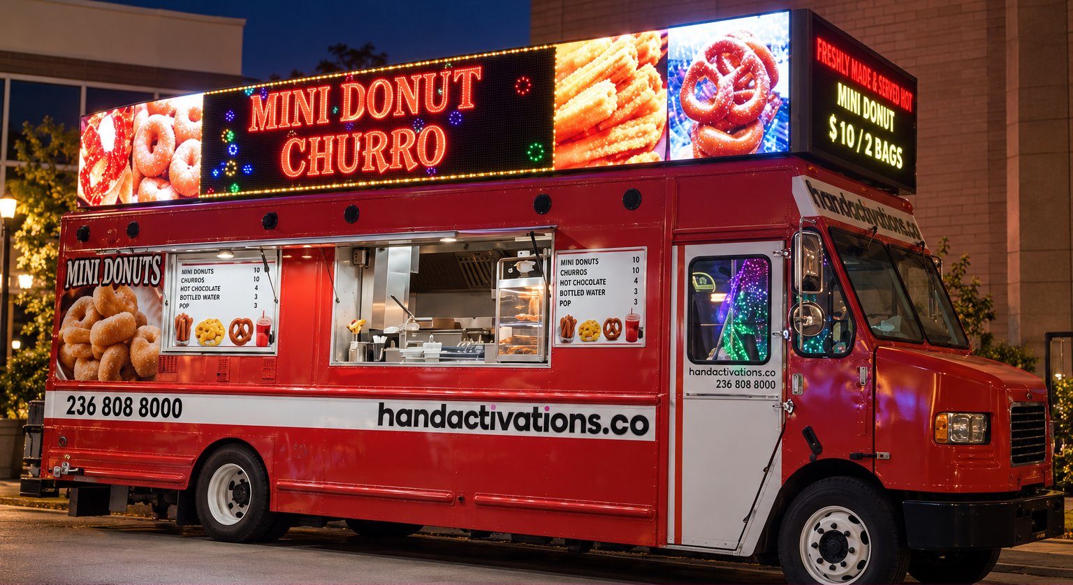 Tin Lizzy LED mini donut truck at night with its LED menu boards lit, serving mini donuts and churros
